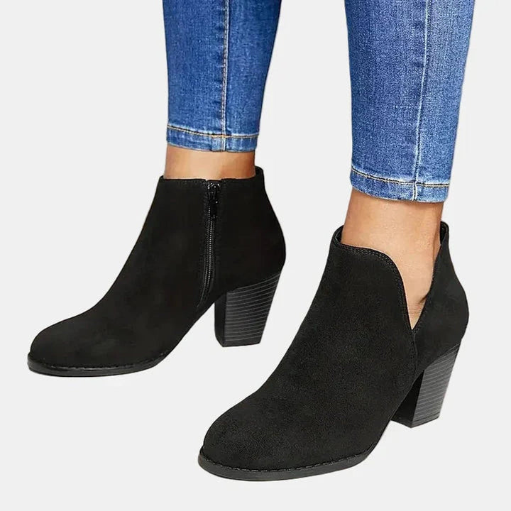 Adeline block heel ankle boots in black, side view with skinny jeans