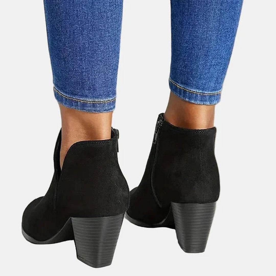 Adeline block heel ankle boots in black, back view showing heel and zip pull