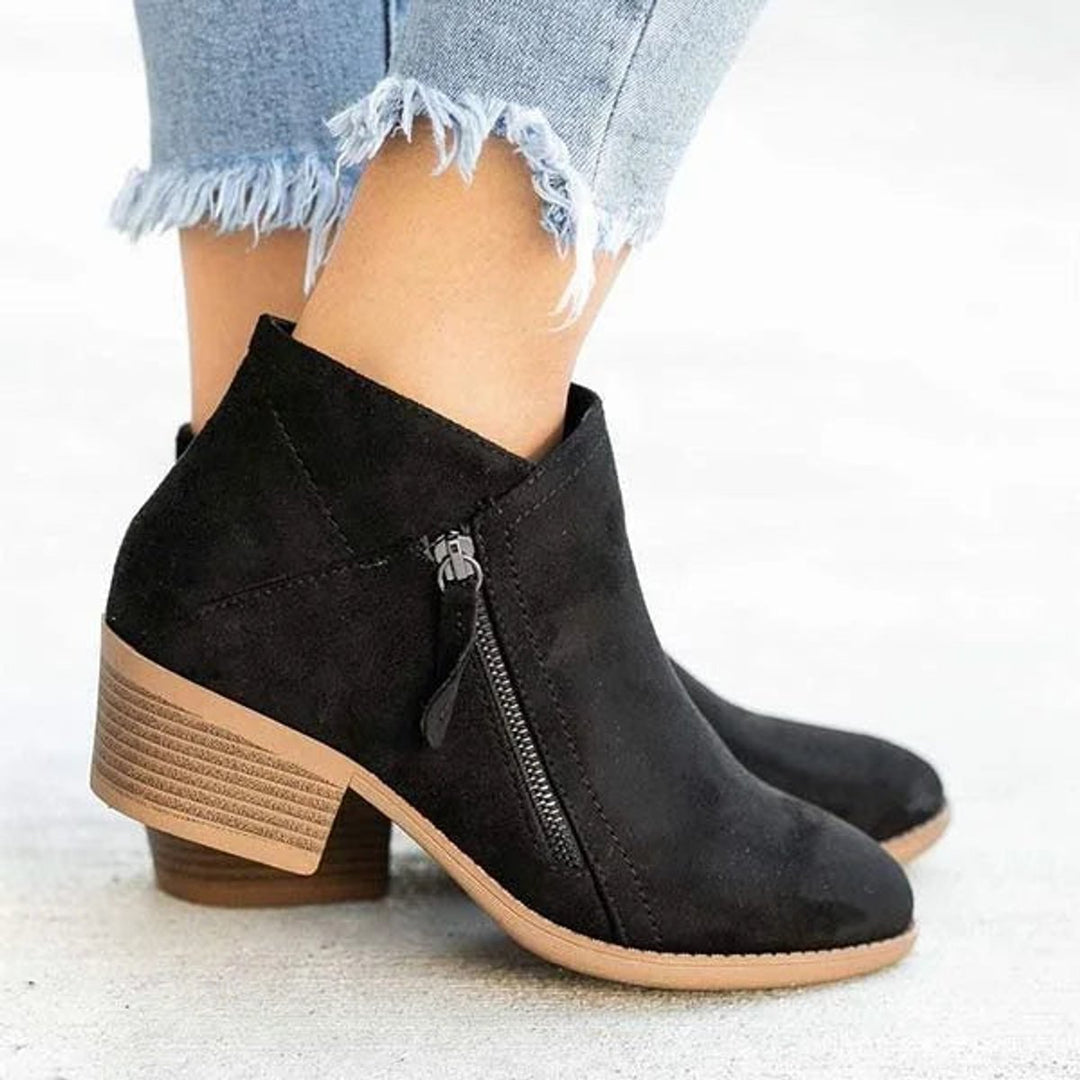 Amara block heel ankle boots in black suede, side profile with zip detail