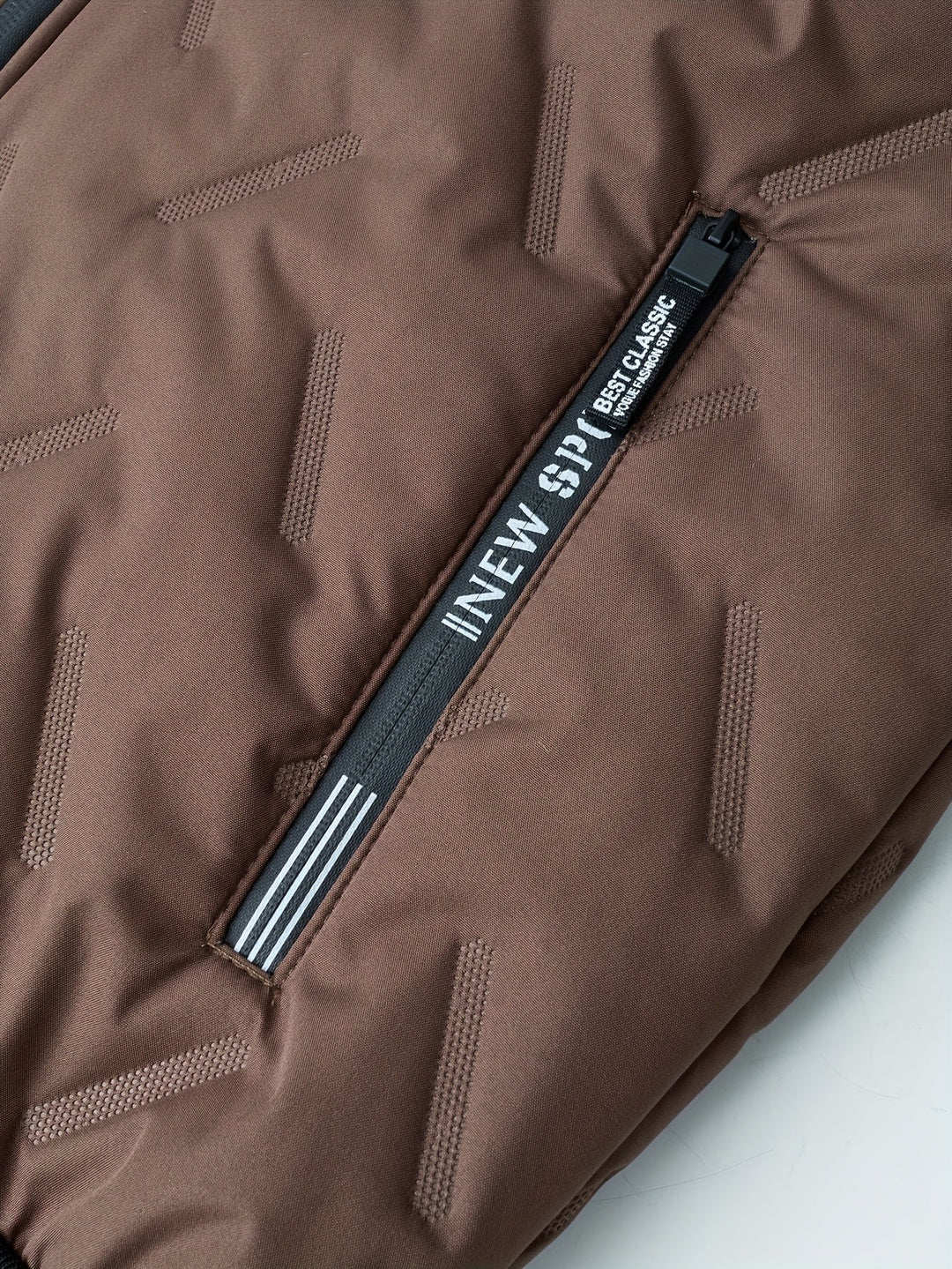 Close-up of Barnaby jacket zip pocket with branded zip pull