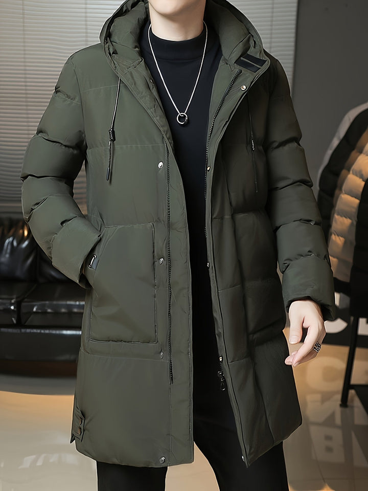 Front view of Barnaby green coat with hood, hand near face