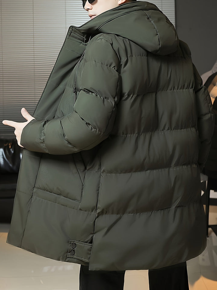 Man wearing Barnaby green coat open, pointing to interior lining