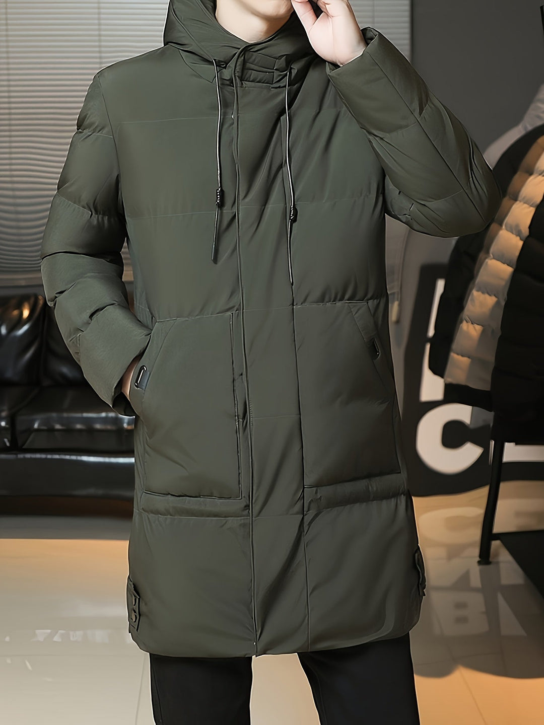 Man wearing Barnaby grey puffer coat, front view with hood up