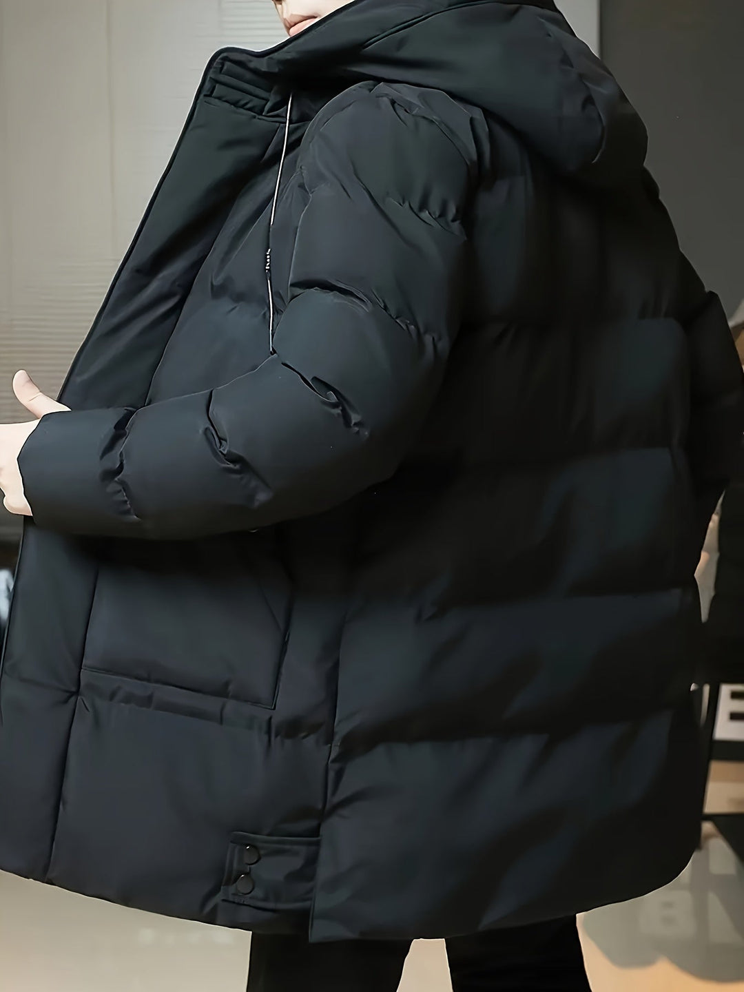 Barnaby black puffer coat, side view showing hood and sleeve detail