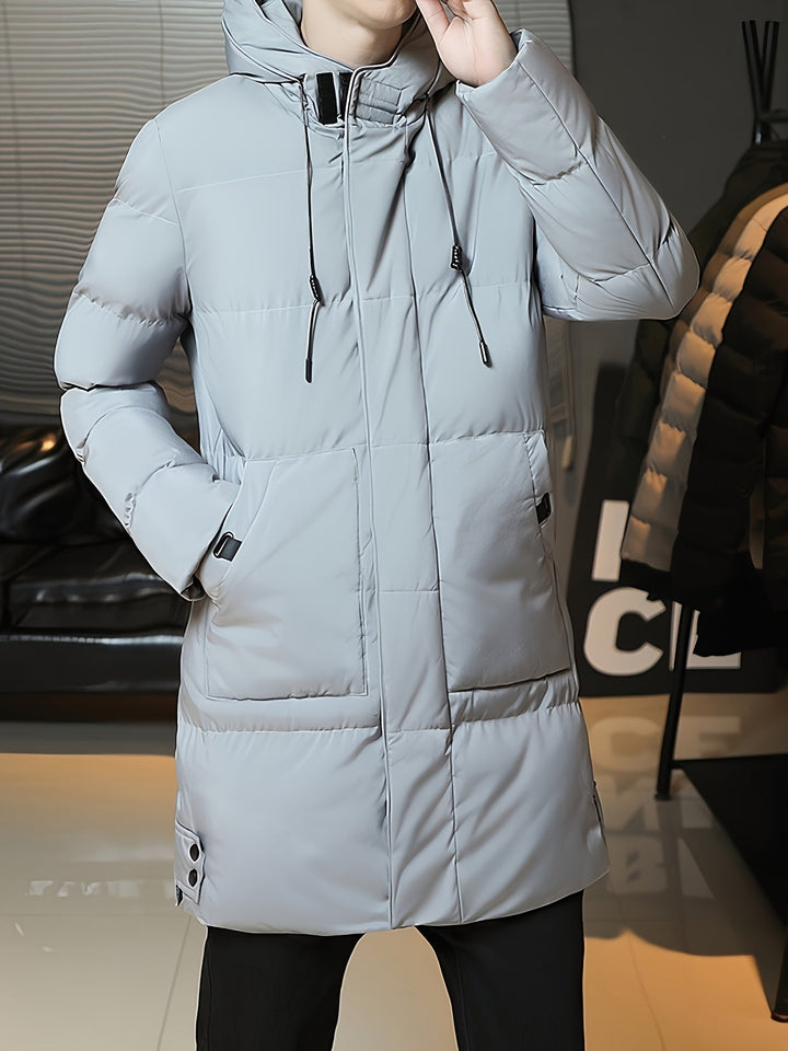 Man wearing Barnaby grey longline coat, holding phone