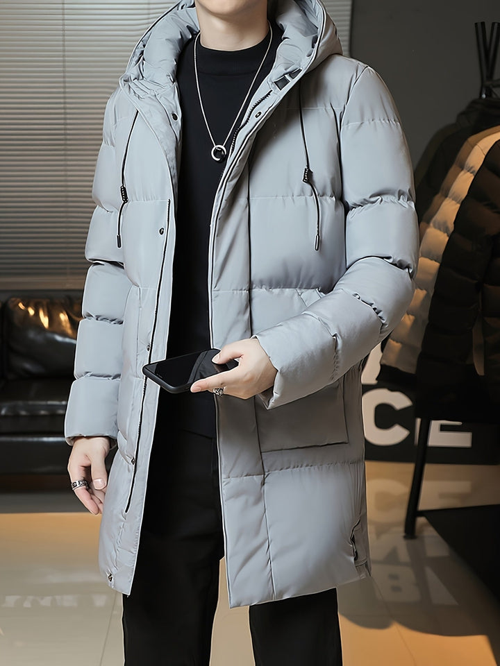 Man wearing Barnaby grey longline coat, holding phone