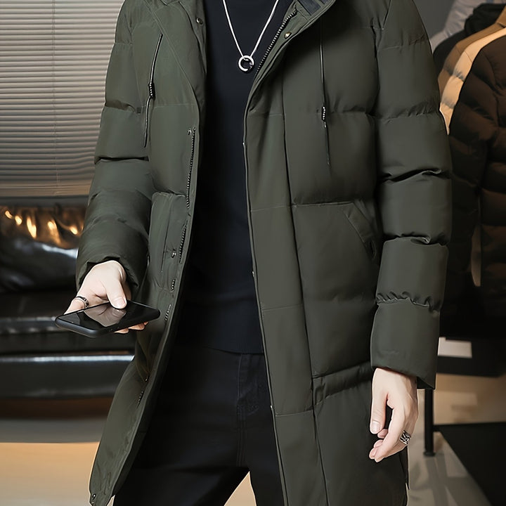 Barnaby hooded longline puffer coat in green, front view with phone in hand