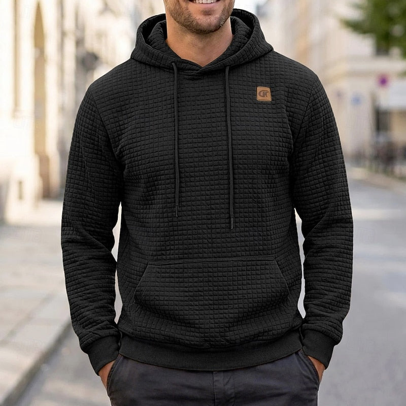 Callum black textured waffle hoodie, front view on model