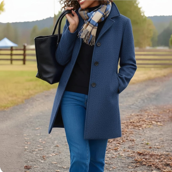 Cecily classic single-breasted mid-length coat in blue, front view with scarf and tote bag