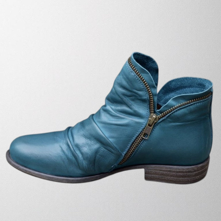 Clementine slouch ankle boot in blue with side zip detail, side view