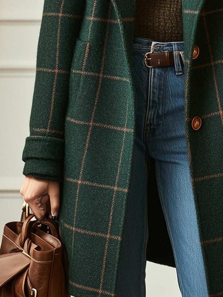 Close-up of Eleanor coat's button detail and pocket, green check