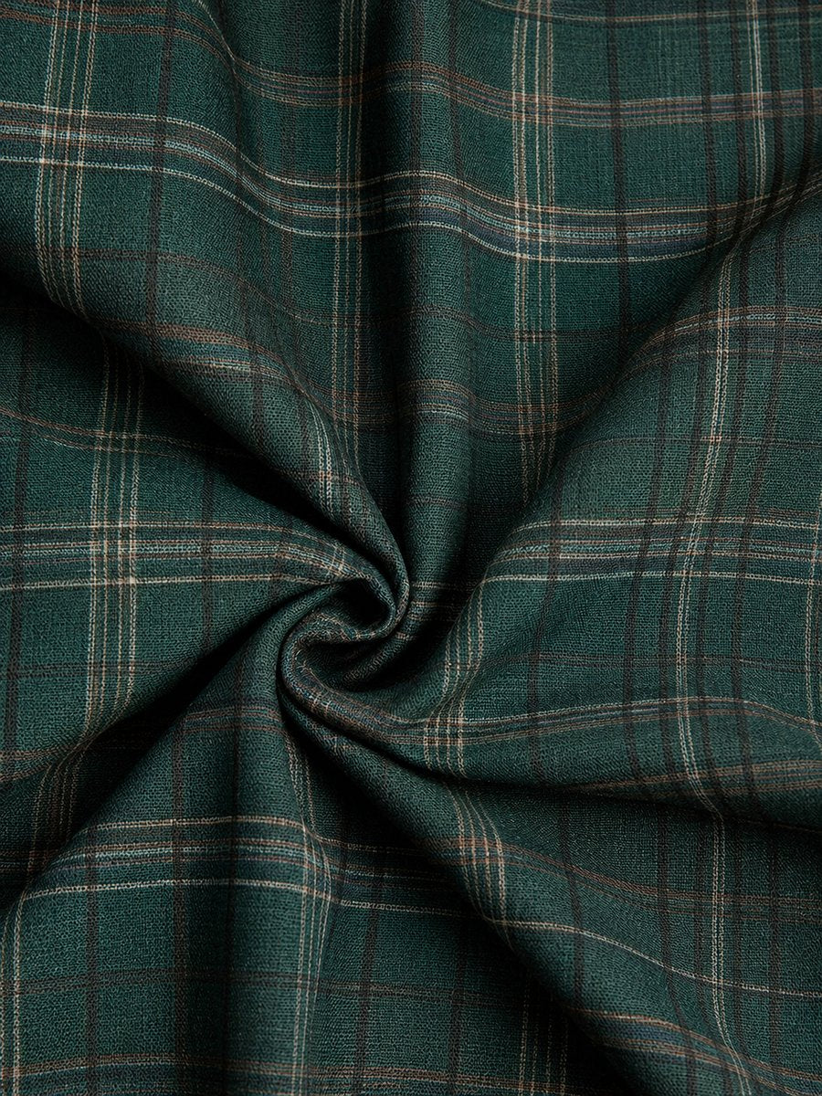Close-up of green plaid flannel fabric texture on Emilia dress