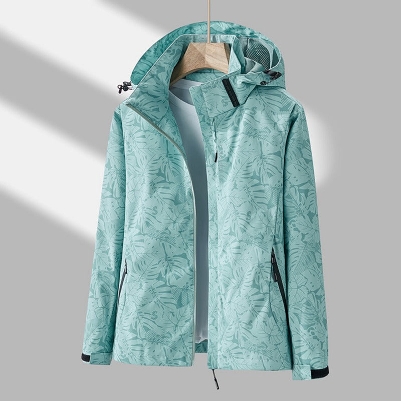 Freya hooded leaf print rain jacket in turquoise, front view on hanger