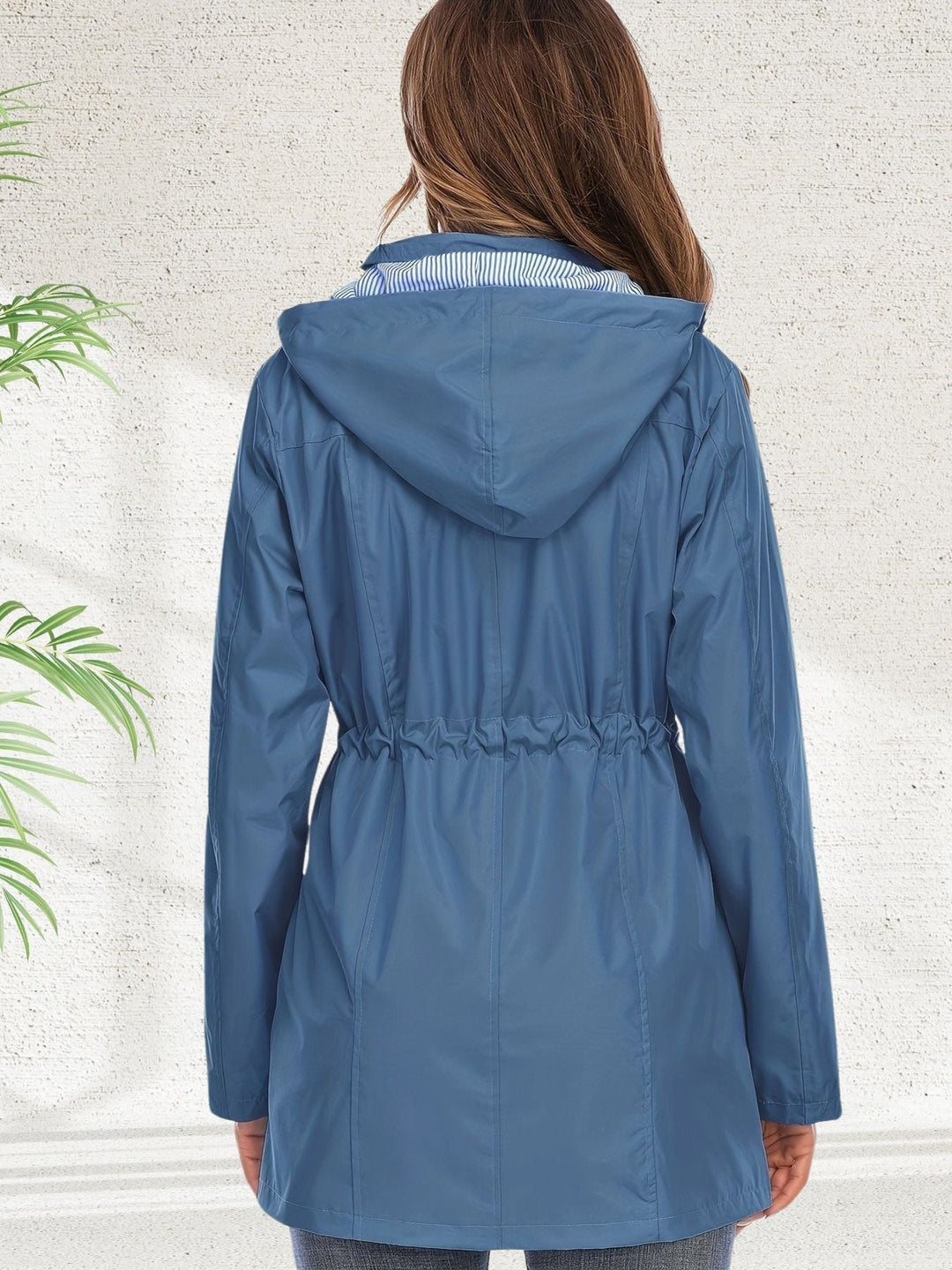 Freya rain jacket back view showing adjustable drawstring waist and hood