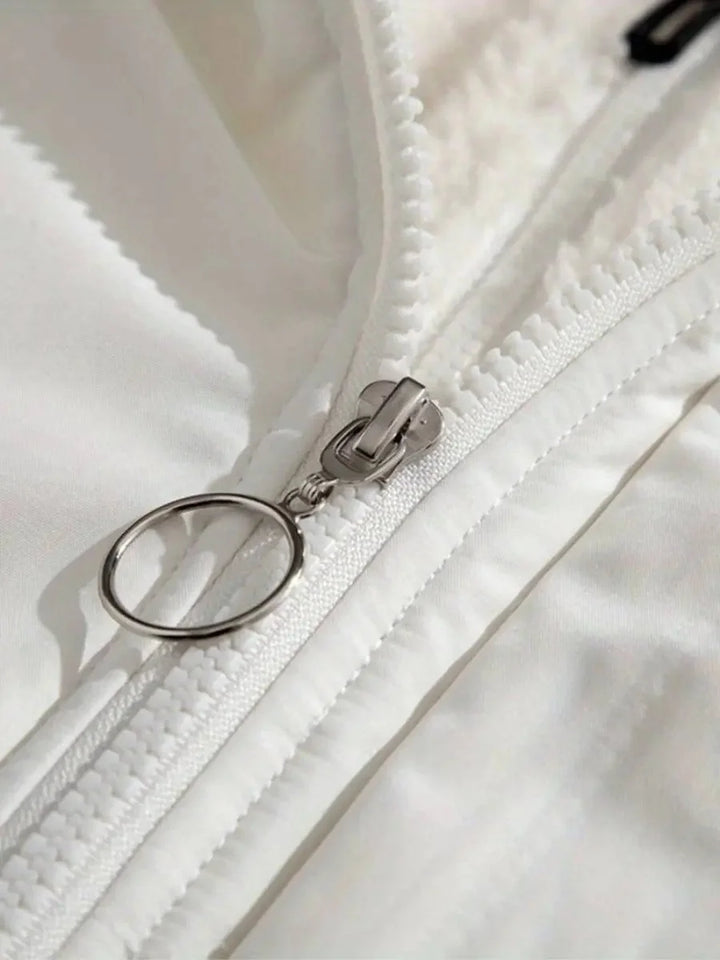 Close-up of zip pull detail on white Josephine puffer jacket