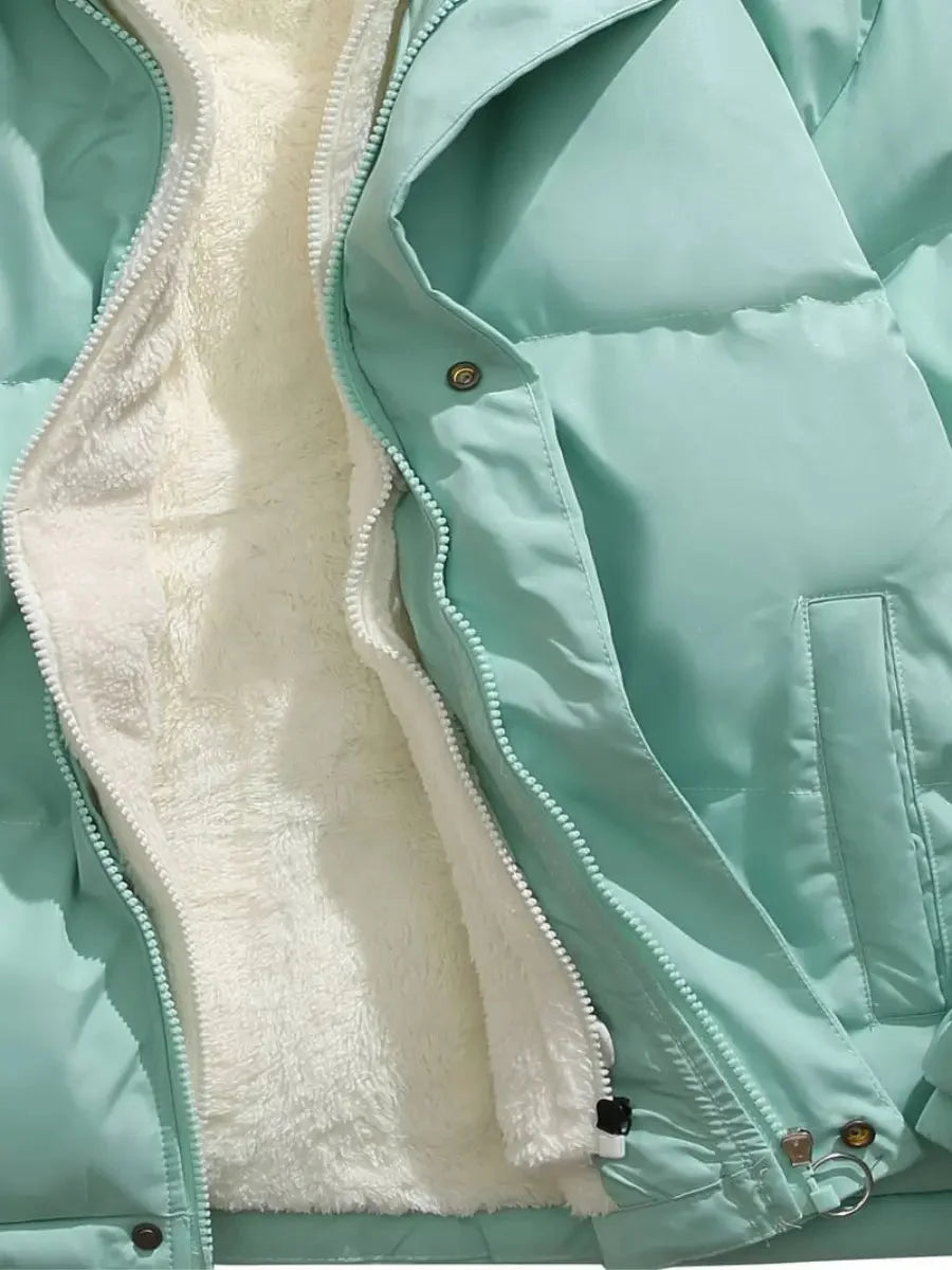 Close-up of open zip and fleece lining on mint green Josephine puffer jacket