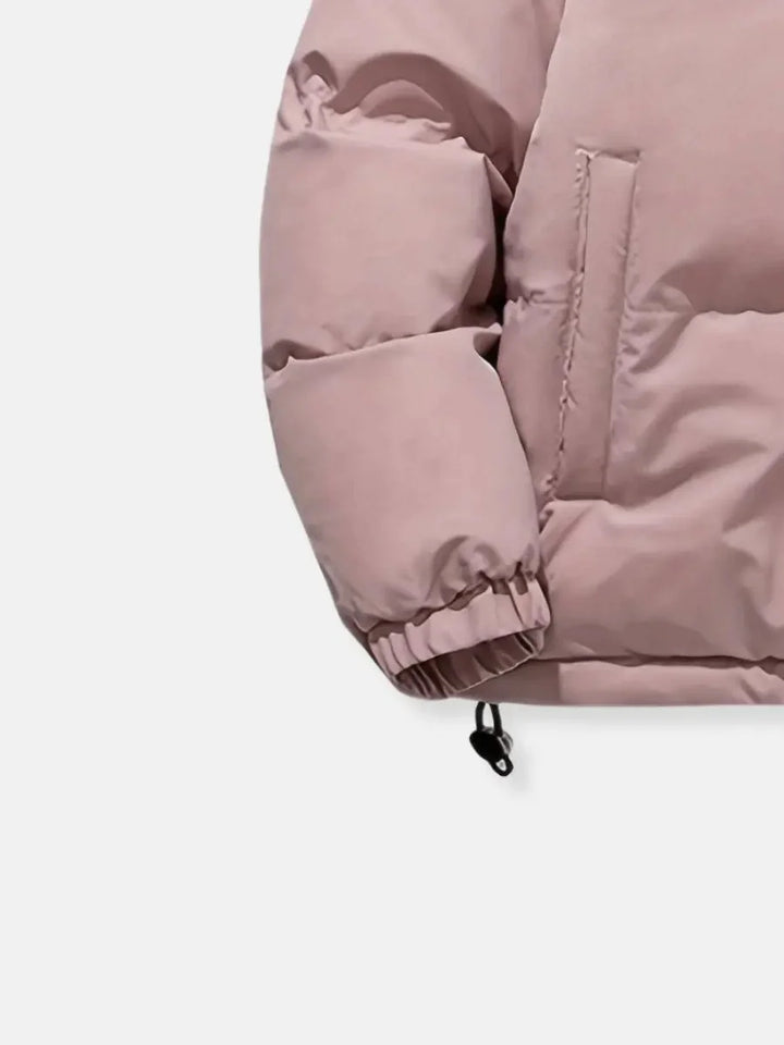 Close-up of cuff and pocket detail on pink Josephine puffer jacket