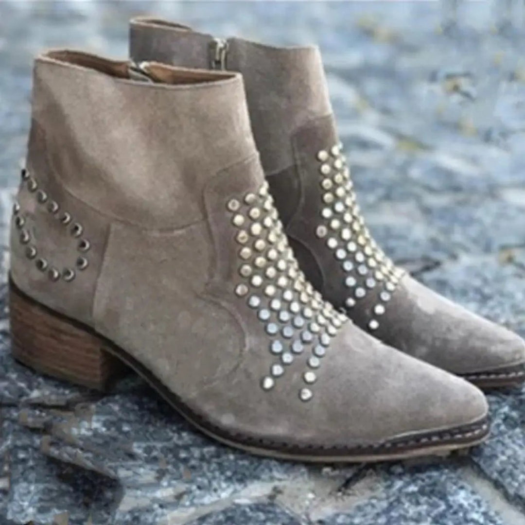 Ottilie studded block heel ankle boots, pair on stone background