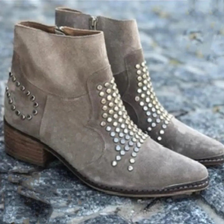 Ottilie studded block heel ankle boots, pair on stone background