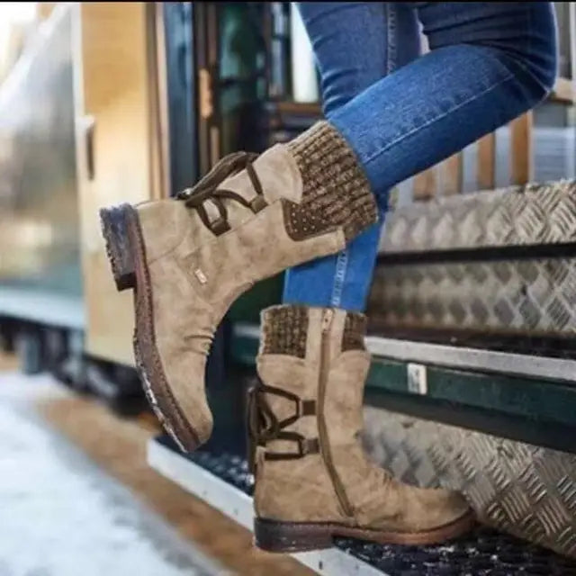 Perpetua khaki lace-up boots worn while stepping onto a ledge