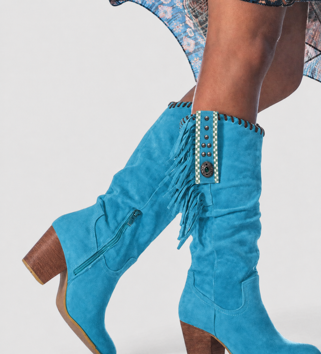 Close-up of Primrose knee-high boots in blue with fringe and studded trim