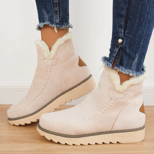 Rosalie fleece lined ankle boots in pale pink, side view worn with jeans