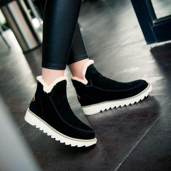 Rosalie fleece lined ankle boots in black, side view on model
