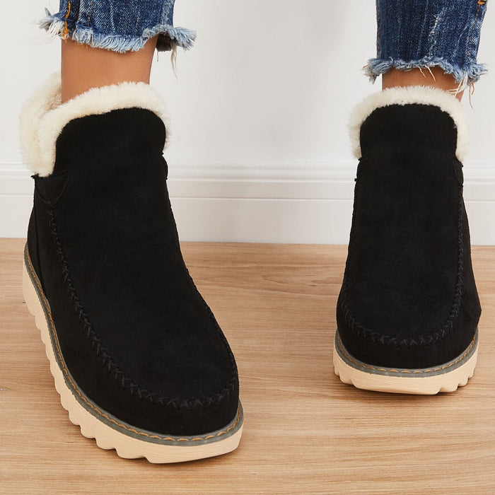 Rosalie fleece lined ankle boots in black, front view worn with jeans