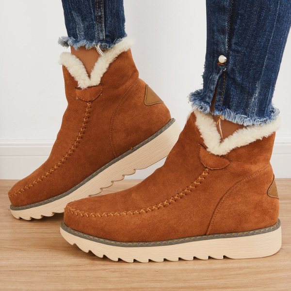 Rosalie fleece lined ankle boots in brown, side view worn with jeans