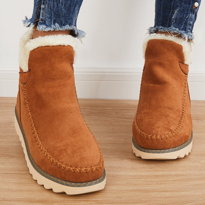 Rosalie fleece lined ankle boots in brown, front view worn with jeans