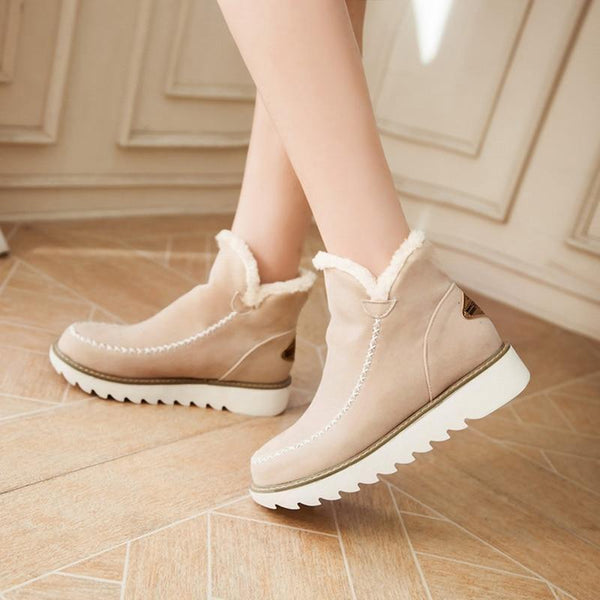 Rosalie fleece lined ankle boots in brown, side view on model