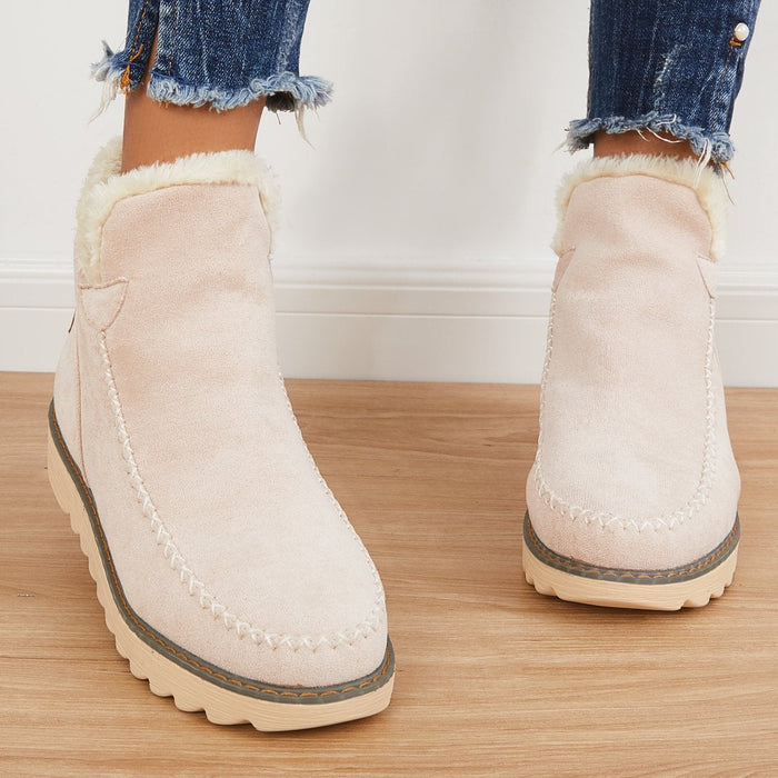 Rosalie fleece lined ankle boots in pale pink, side view worn with jeans
