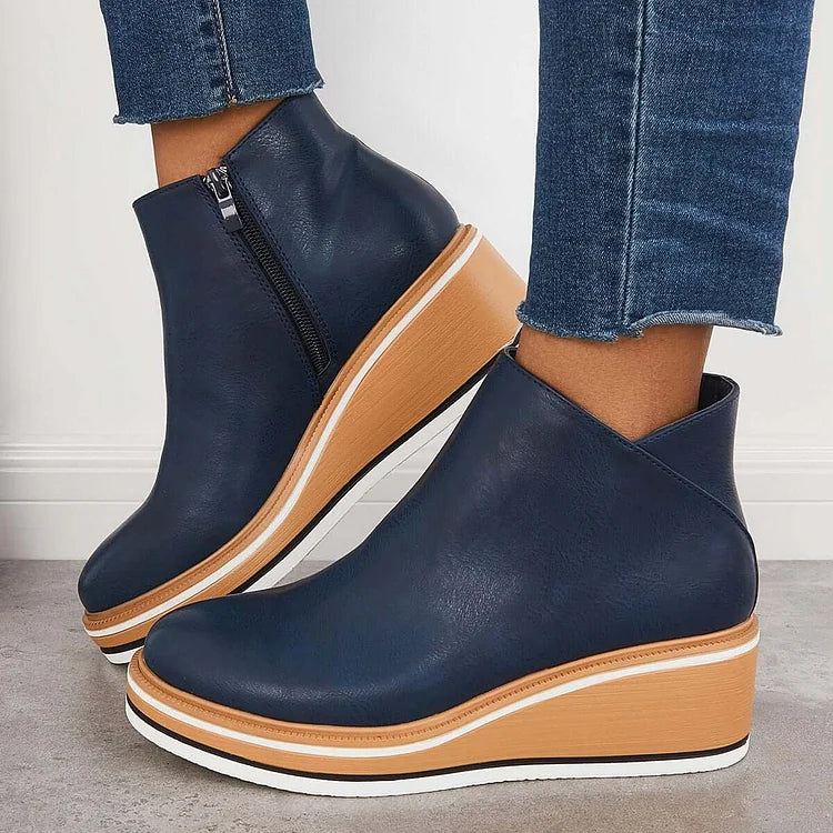 Rosalie navy wedge platform ankle boots on model, side profile