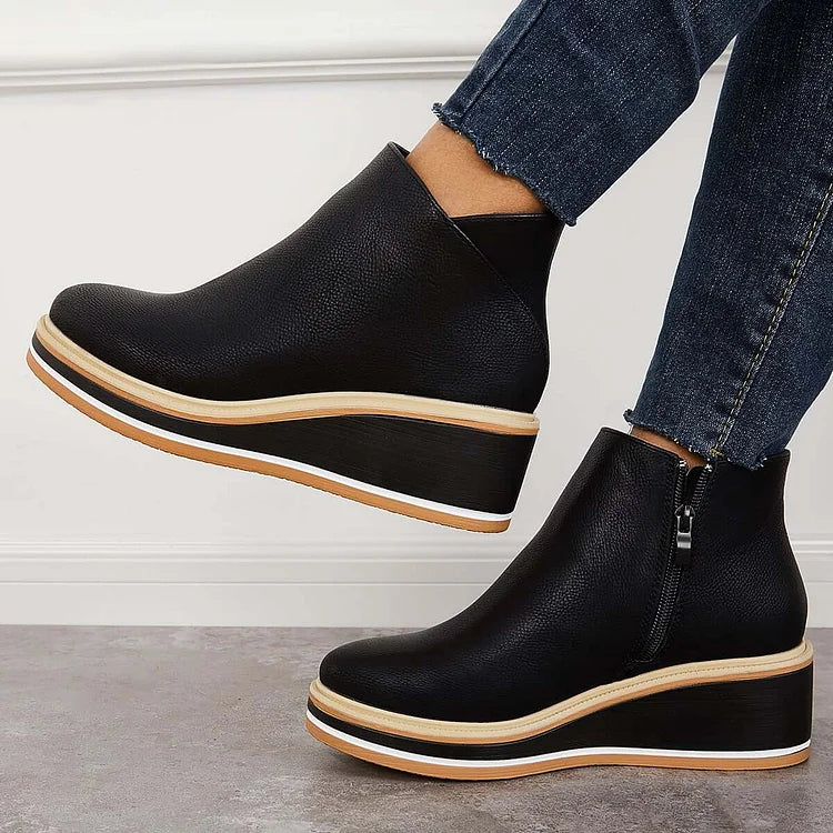 Rosalie black wedge platform ankle boots on model, angled view