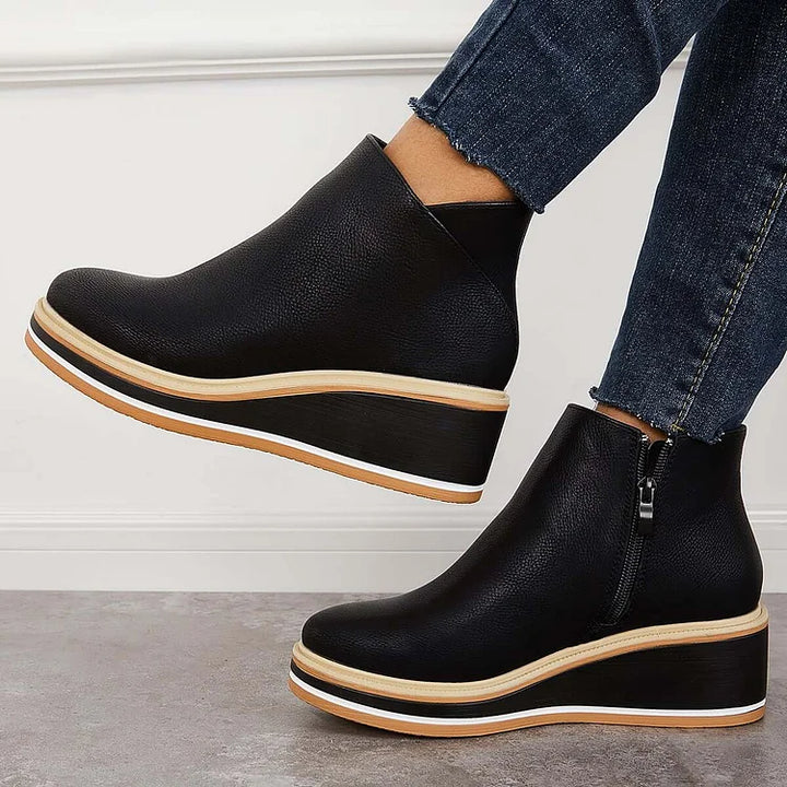 Rosalie black wedge platform ankle boots on model, angled view
