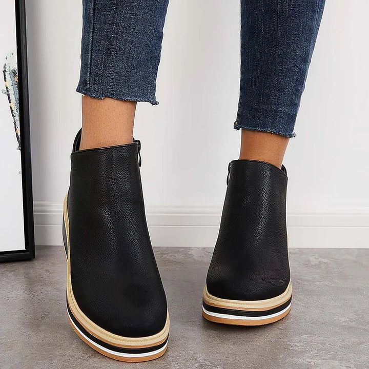Rosalie black wedge platform ankle boots on model, back view