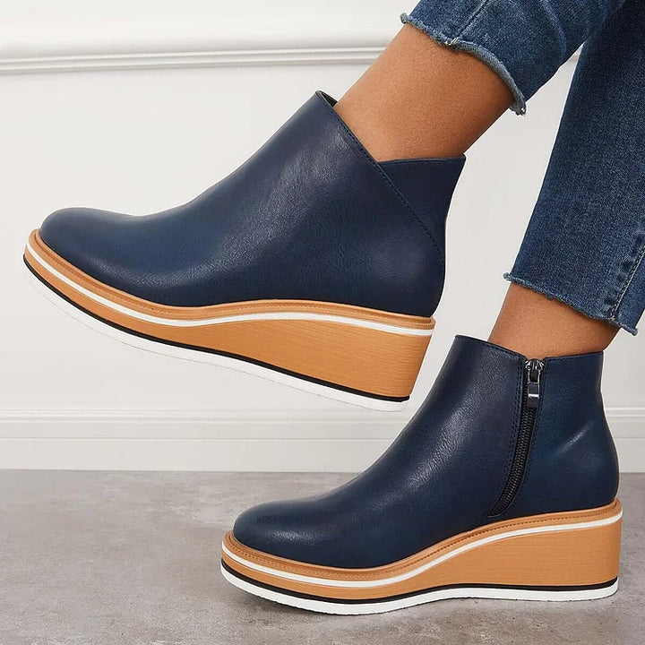 Rosalie navy wedge platform ankle boots on model, front angle