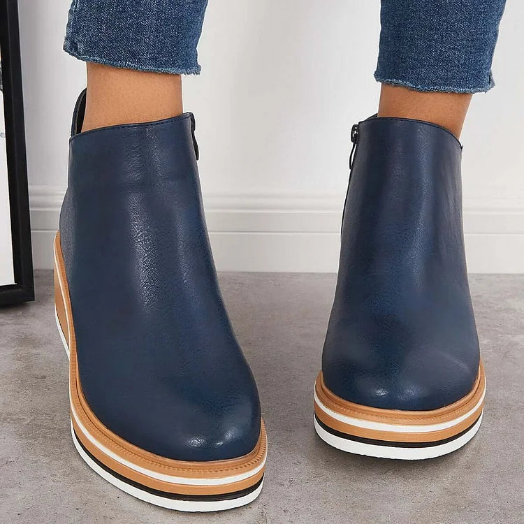 Rosalie navy wedge platform ankle boots on model, back view