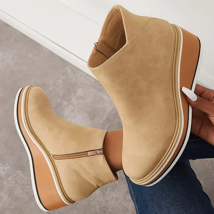 Rosalie beige wedge platform ankle boots held by hand, sole detail