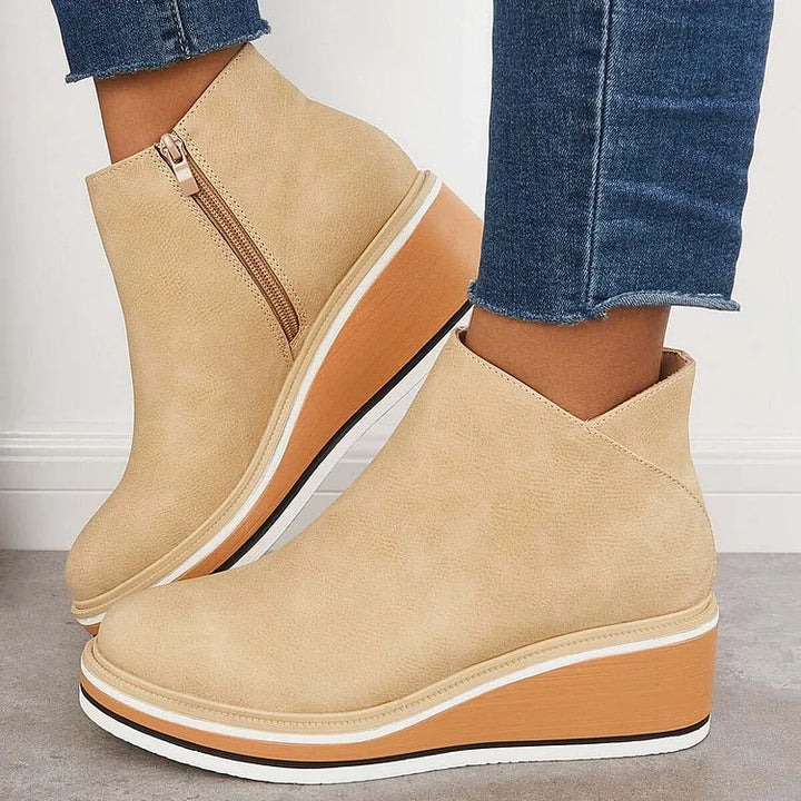 Rosalie beige wedge platform ankle boots on model, side profile