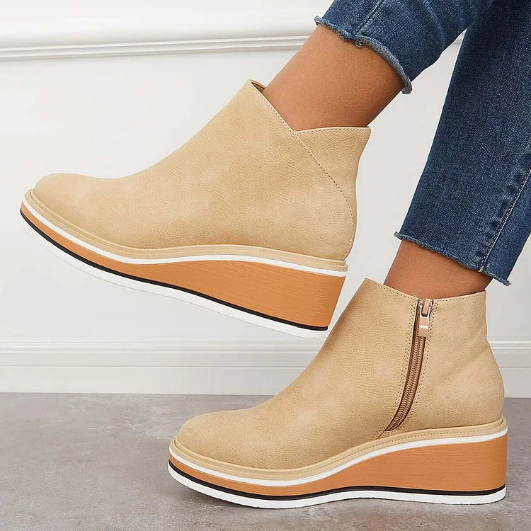 Rosalie beige wedge platform ankle boots on model, angled view