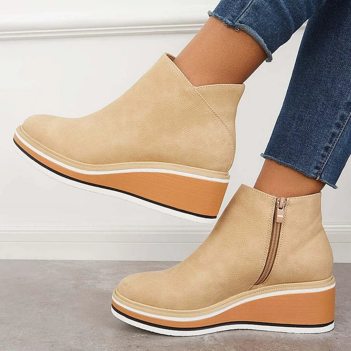 Rosalie beige wedge platform ankle boots on model, angled view