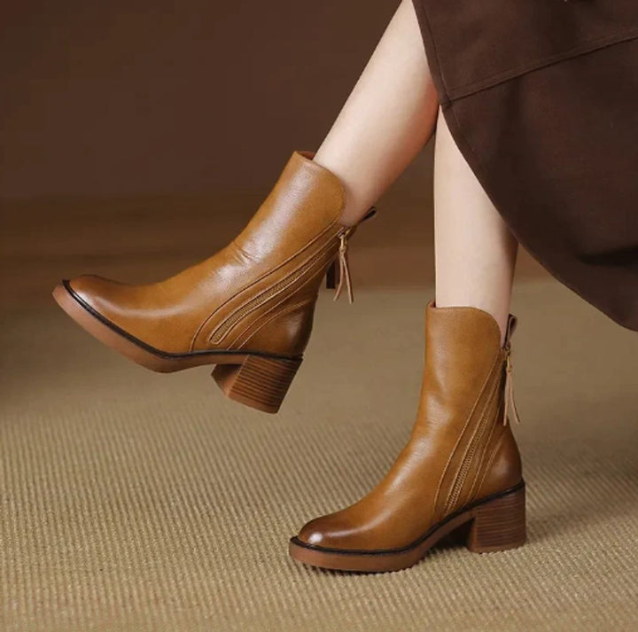 Rosalind leather block heel ankle boots, side view on model crossing legs