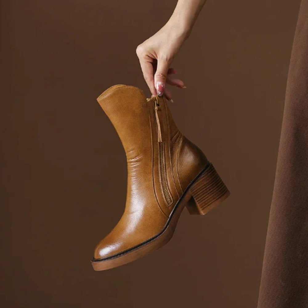 Rosalind ankle boot held by hand showing side zip and heel detail