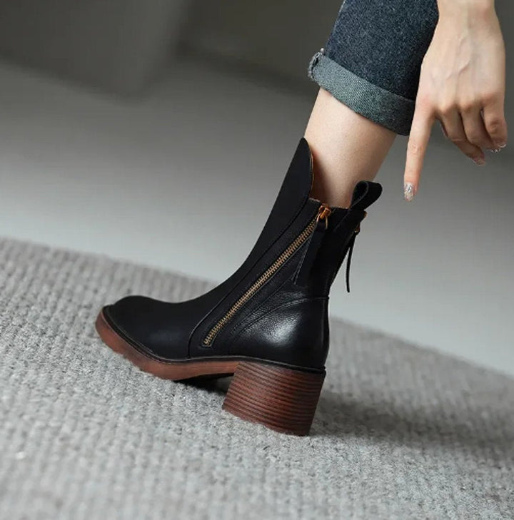 Black Rosalind ankle boot on model's foot, close-up rear angle