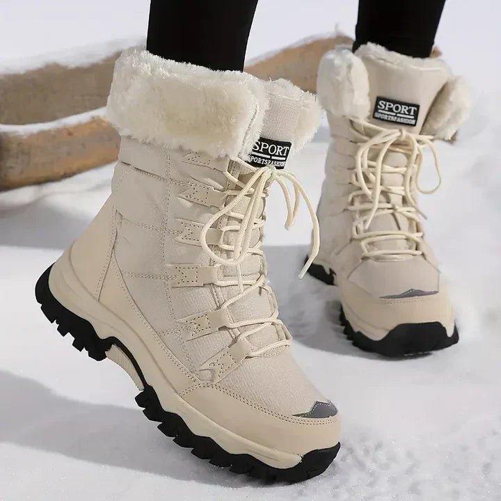 Verity beige fur trim lace-up snow boots worn outdoors in the snow, front angle