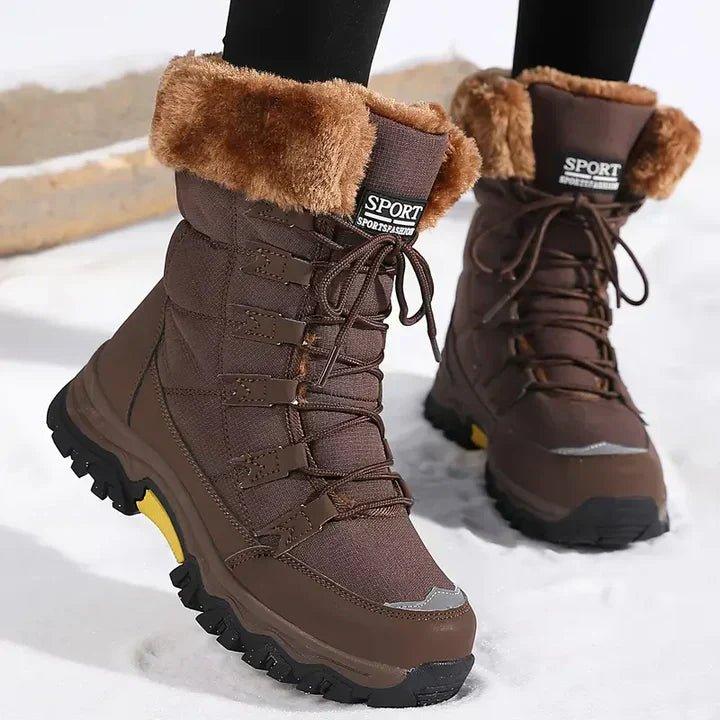 Verity brown fur trim lace-up snow boots worn outdoors in the snow, side angle