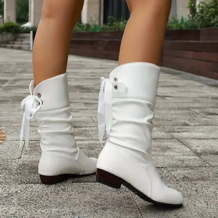 Verity white lace-up calf boots, side profile walking