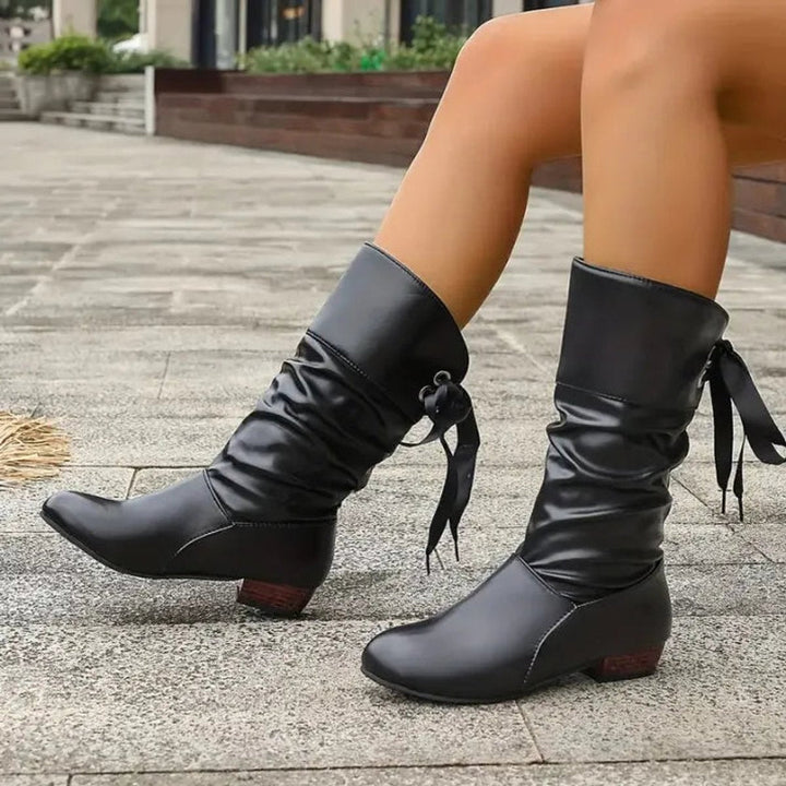 Verity black ruched calf boots, walking pose