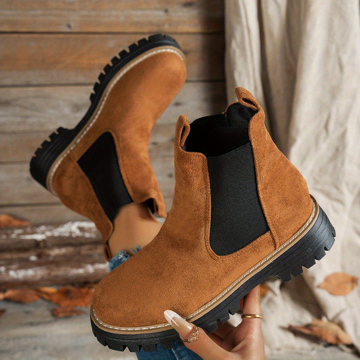 Brown Chelsea boots shown from above, soles facing camera